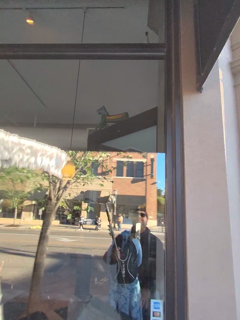 Squeegee pass across a storefront window