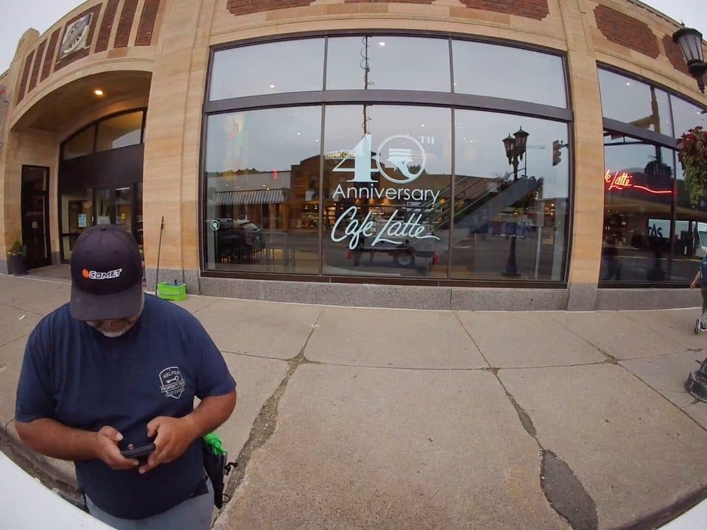 Window Cleaning Team member outside a downtown storefront