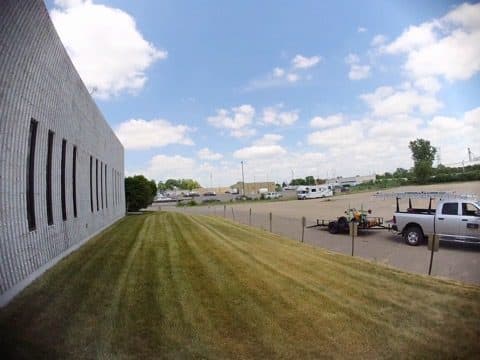 Freshly mowed lawn beside a commercial building
