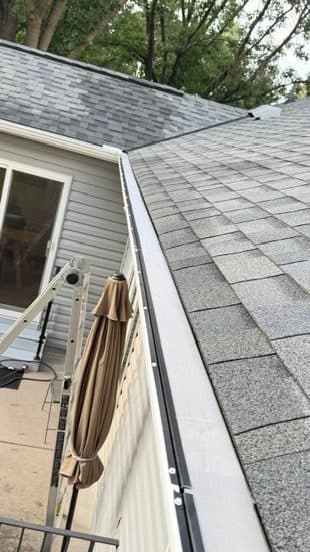 Gutter edge along a shingle roof