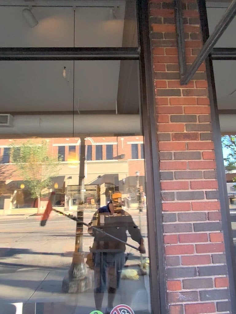 Squeegee pass on a brick-front storefront