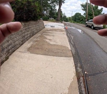 Sidewalk halfway through a pressure wash