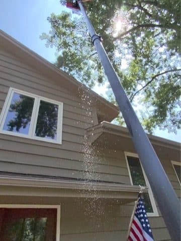 Low-pressure rinse on siding under the eave