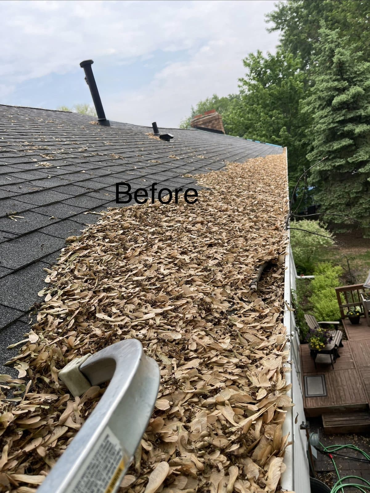 Gutter packed with debris before cleaning