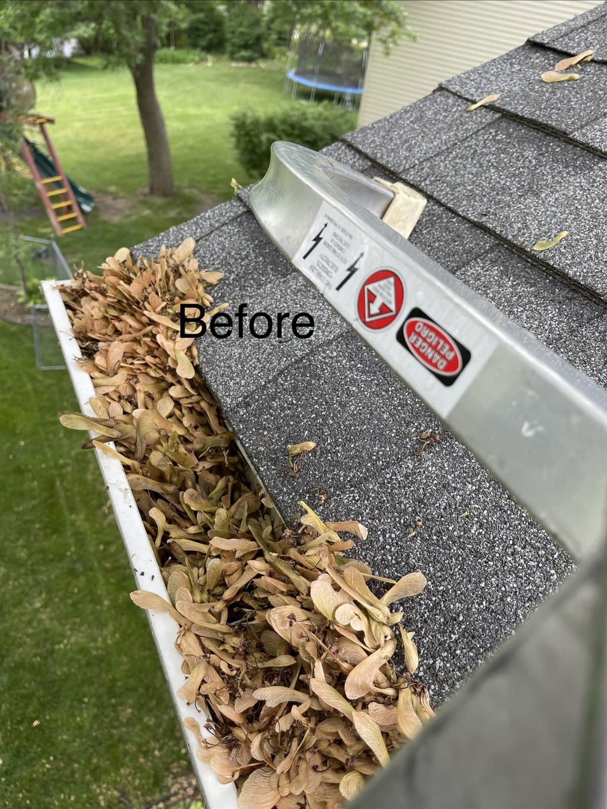 Leaves in a gutter before cleaning
