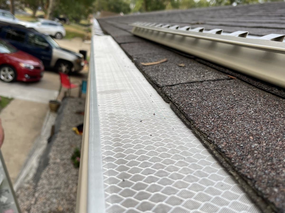 Gutter guard along a roofline, seen from the ladder