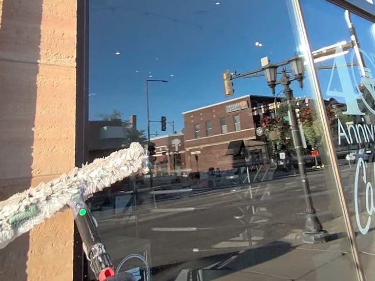 Scrubbing a downtown storefront window